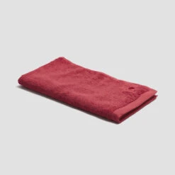 Mineral Red Organic Cotton Hand Towel -Home Luxury Store PigletinBed BathroomCollection OrganicCottonHandTowel MineralRed 1 GreyBG 5b22503b 67db 4797 9a38 2a0228a1121c